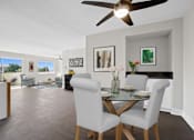 Thumbnail 4 of 22 - A dining room with a glass table and chairs.