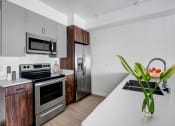 Thumbnail 16 of 83 - a kitchen with stainless steel appliances and a white counter top