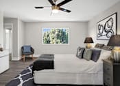 Thumbnail 15 of 22 - A bedroom with a bed, a chair, and a ceiling fan.