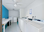 Thumbnail 17 of 19 - A laundry room with a washer and dryer.