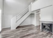Thumbnail 30 of 62 - a living room with a staircase and a fireplace