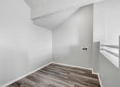 Thumbnail 32 of 62 - an empty room with white walls and a wooden floor
