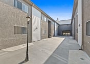 Thumbnail 7 of 8 - an alleyway between two buildings with a street light