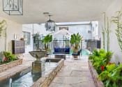 Thumbnail 11 of 17 - a living room with a fountain and a pool