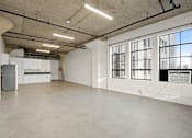 Thumbnail 20 of 92 - A large empty room with a concrete floor and walls.