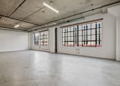 Thumbnail 15 of 92 - A large empty room with a window on the right side.