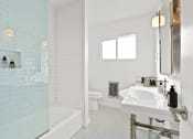Thumbnail 10 of 17 - a white bathroom with a sink and a shower and a toilet