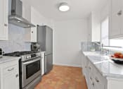 Thumbnail 8 of 17 - a kitchen with stainless steel appliances and white cabinets