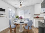 Thumbnail 9 of 61 - a dining room with a table and chairs and a ceiling fan