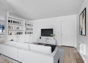 Thumbnail 12 of 61 - a living room with a white couch and a tv