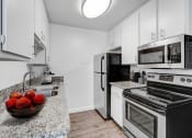 Thumbnail 7 of 61 - a kitchen with stainless steel appliances and granite counter tops