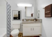 Thumbnail 16 of 61 - a bathroom with a toilet and a sink and a shower