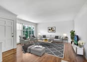 Thumbnail 13 of 35 - a living room with white walls and hardwood floors