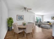 Thumbnail 14 of 35 - a dining room and living room with white walls and hardwood floors