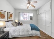 Thumbnail 16 of 35 - a bedroom with a large bed and a ceiling fan