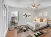 Thumbnail 15 of 35 - a bedroom with a large bed and a ceiling fan