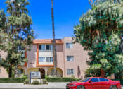 Thumbnail 20 of 20 - a red car parked in front of an apartment building