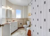 Thumbnail 18 of 35 - a bathroom with a shower and a sink
