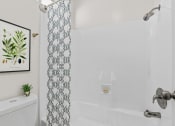 Thumbnail 17 of 20 - a bathroom with a shower and a toilet and a shower curtain