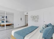 Thumbnail 15 of 20 - a bedroom with a large bed and a mirror