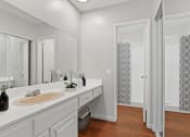 Thumbnail 8 of 20 - a bathroom with a sink and a mirror and a shower