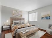 Thumbnail 6 of 20 - a bedroom with a bed and a couch and a window
