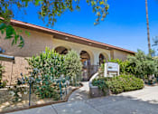 Thumbnail 7 of 8 - a building with a sign in front of it and trees