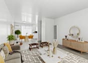 Thumbnail 3 of 8 - a living room with a couch and a table and a mirror