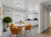 Thumbnail 2 of 8 - an open kitchen and dining room with a table and chairs