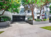 Thumbnail 10 of 16 - a gated driveway in front of an apartment building
