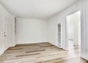 Thumbnail 3 of 5 - a bedroom with hardwood floors and white walls