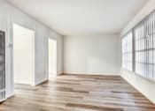 Thumbnail 2 of 5 - a bedroom with hardwood floors and white walls