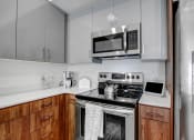 Thumbnail 1 of 83 - a kitchen with stainless steel appliances and a microwave