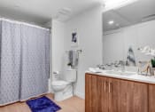 Thumbnail 11 of 83 - a bathroom with a shower and a sink and a toilet