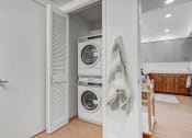 Thumbnail 10 of 83 - a small laundry room with a washing machine and a door