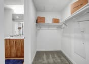 Thumbnail 9 of 83 - a white closet with boxes and hangers on a shelf