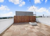 Thumbnail 15 of 83 - a roof terrace with wooden tiles and a wooden privacy fence