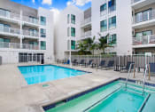 Thumbnail 14 of 83 - a swimming pool in front of an apartment building