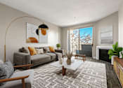 Thumbnail 11 of 26 - A living room with a grey sofa, a coffee table, and a fireplace.