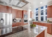 Thumbnail 51 of 95 - a large kitchen with stainless steel appliances and granite counter tops