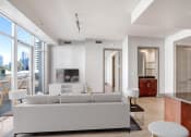 Thumbnail 61 of 95 - a white living room with a couch and a tv