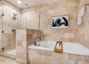 Thumbnail 48 of 95 - a bathroom with a bath tub and a shower