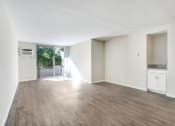 Thumbnail 23 of 23 - an empty living room with white walls and a sliding glass door