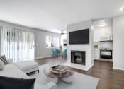 Thumbnail 10 of 61 - a living room with a couch and a table and a fireplace