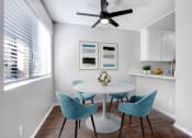 Thumbnail 9 of 61 - a dining room with a table and chairs and a ceiling fan