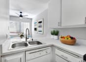 Thumbnail 8 of 61 - a white kitchen with a sink and a window
