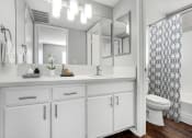 Thumbnail 15 of 61 - a white bathroom with a shower and a sink