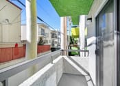 Thumbnail 12 of 61 - a balcony with a white railing and a green roof