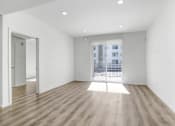 Thumbnail 37 of 42 - an empty living room with wood floors and a balcony