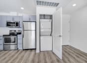 Thumbnail 6 of 42 - a kitchen with stainless steel appliances and white cabinets